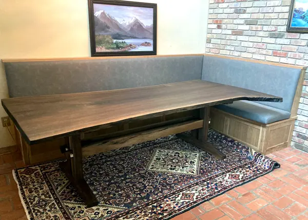 Live edge walnut slab dining table and cherry banquette