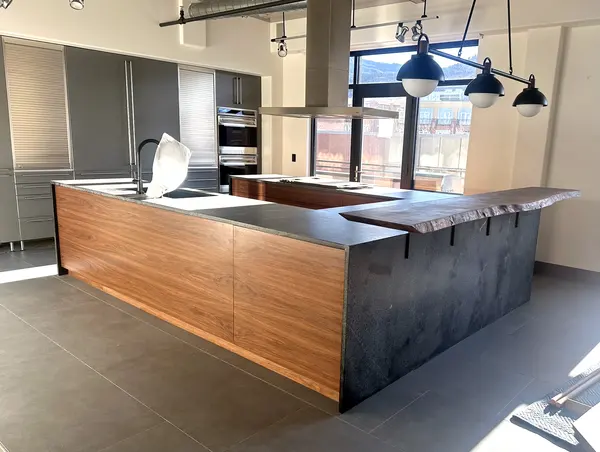 Walnut flat panel custom kitchen cabinets with stone countertops